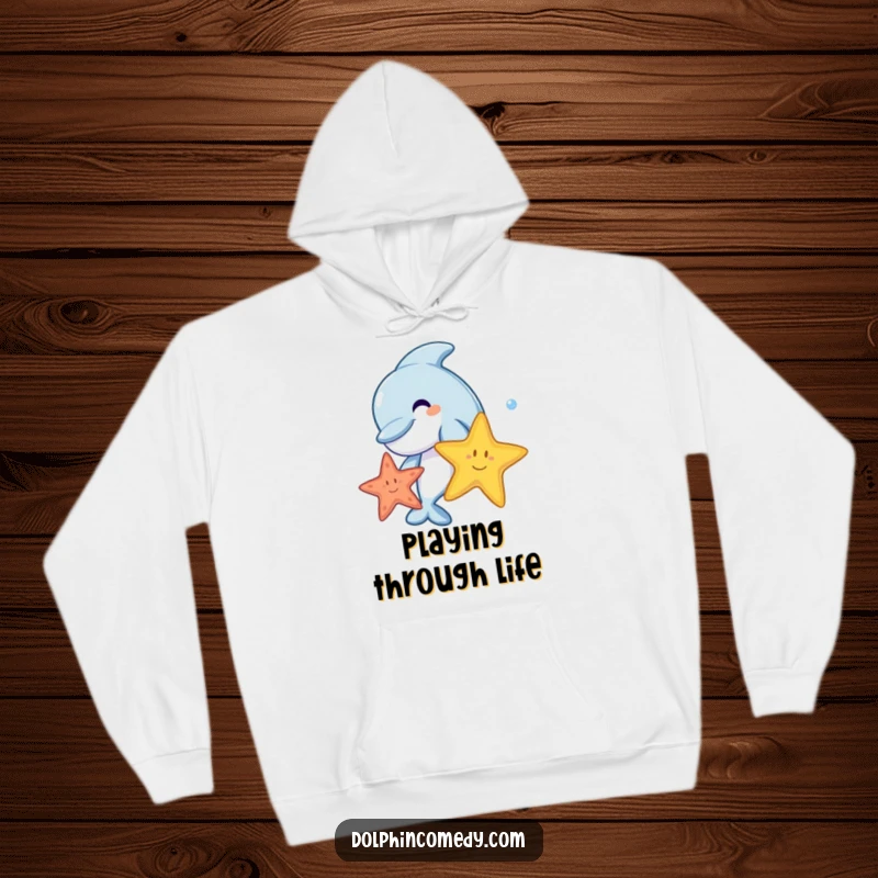 A joyful cartoon dolphin swimming and playing with a colorful starfish, depicted on a soft, humorous hoodie.